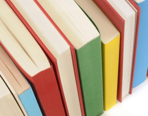 Plain black book with row of colorful books